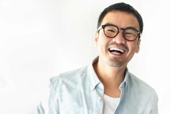 portrait happy cheerful young  asian man with perfect smilling,clean skin.posing show white teeth smile relaxing on white bacjground.fashion people freedom life style concept